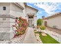 Inviting front entrance with decorative plants, rock landscaping, and a charming walkway at 3912 E Rockwood Dr, Phoenix, AZ 85050