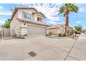 Front elevation of home, showcasing desert landscaping, a two-car garage, and a well-maintained lawn at 3912 E Rockwood Dr, Phoenix, AZ 85050
