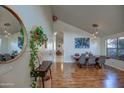 Bright dining room with hardwood floors, modern light fixtures, and large windows at 4350 E Abraham Ln, Phoenix, AZ 85050