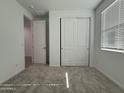 Bedroom with plush carpet, white walls, closet and door leading to other parts of house at 4439 S 95Th Dr, Tolleson, AZ 85353