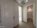 Bright foyer with wood-look flooring, white trim, and views into the home at 4439 S 95Th Dr, Tolleson, AZ 85353