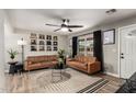 Inviting living room with neutral walls, wood-look floors, and modern decor for a cozy gathering space at 4839 W Juniper Ave, Glendale, AZ 85306