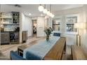 Inviting dining room showcasing a modern light fixture and a view into the bedroom at 5104 N 32Nd St # 105, Phoenix, AZ 85018