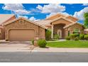 Charming single-story home featuring a stone-accented facade, tile roof, and well-manicured landscaping at 518 S Bay Shore Blvd, Gilbert, AZ 85233