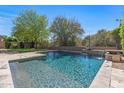Sparkling pool featuring a waterfall feature, surrounded by well-manicured landscaping at 5813 E Ashler Hills Dr, Cave Creek, AZ 85331