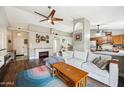 Comfortable living room showcasing a modern fireplace, wood floors, and an open layout with the kitchen at 6335 E Brown Rd # 1084, Mesa, AZ 85205