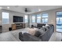 Cozy living room featuring a comfortable sectional sofa, modern fireplace, and view of the backyard at 6983 W Andrea Dr, Peoria, AZ 85383