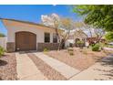 Beautiful single-story home boasts a private garage, xeriscaped front yard, and a paved driveway, blending charm and low-maintenance living at 815 W Juniper Ln, Litchfield Park, AZ 85340