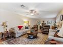 Cozy living room featuring neutral-toned furnishings, a ceiling fan, and a decorative rug at 8202 E Coolidge St, Scottsdale, AZ 85251