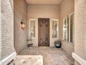 Welcoming front porch with a decorative metal door and tiled flooring at 8654 W Melinda Ln, Peoria, AZ 85382