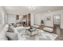 Open-concept living room featuring a modern fireplace, sleek furniture, and wood flooring throughout at 951 E Jacob St, Chandler, AZ 85225