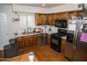 An efficient kitchen features wood cabinets, stainless appliances and white subway tile at 1108 S Lebanon Ln, Tempe, AZ 85288
