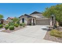 Charming single-story home with a well-maintained front yard and a spacious driveway leading to a two-car garage at 12062 W Duane Ln, Peoria, AZ 85383