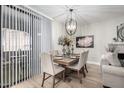 Stylish dining area with modern chandelier, seating for six, and natural light at 15252 N 100Th St # 1154, Scottsdale, AZ 85260