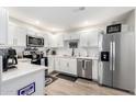 Bright kitchen with stainless steel appliances, white cabinets, and quartz countertops at 15252 N 100Th St # 1154, Scottsdale, AZ 85260