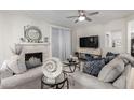 Comfortable living room with fireplace, ceiling fan, and sliding glass door at 15252 N 100Th St # 1154, Scottsdale, AZ 85260