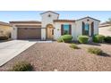 Charming single-story home showcasing a low-maintenance desert landscape and a two-car garage at 19351 E Apricot Ln, Queen Creek, AZ 85142