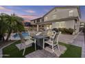 Outdoor oasis featuring a sparkling pool, palm tree, a covered patio and fire pit for backyard entertaining at 21978 N 100Th Ave, Peoria, AZ 85383