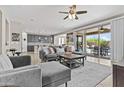 Inviting living room with a large sliding glass door, and seamless access to the backyard pool area at 21978 N 100Th Ave, Peoria, AZ 85383