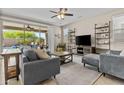 Comfortable living room featuring neutral decor and an entertainment center with ample storage at 21978 N 100Th Ave, Peoria, AZ 85383