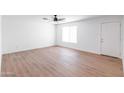 Bright, airy living room features wood-look floors, neutral walls, and a window at 3212 N 49Th Ln, Phoenix, AZ 85031