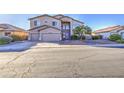 Two-story home with a three-car garage, desert landscaping, and inviting curb appeal at 43324 W Desert Fairways Dr, Maricopa, AZ 85138