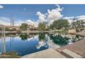 Beautiful water view showcasing waterfront homes and blue sky with clouds at 514 E Vaughn Ave, Gilbert, AZ 85234