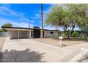 Charming single-story home featuring a xeriscaped yard, carport, and painted brick exterior at 11842 N 30Th Dr, Phoenix, AZ 85029