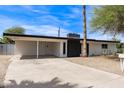 Charming single-story home featuring a xeriscaped yard, carport, and painted brick exterior at 11842 N 30Th Dr, Phoenix, AZ 85029