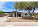 Charming single-story home featuring a xeriscaped yard, carport, and painted brick exterior at 11842 N 30Th Dr, Phoenix, AZ 85029