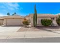 Charming single-story home with desert landscaping, a two-car garage, and a private gated courtyard at 14207 W Kiowa Trl, Surprise, AZ 85374