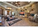 Beautiful living room with a stone fireplace, custom built-ins, and coffered ceilings at 1423 E Breezy Ct, Phoenix, AZ 85086