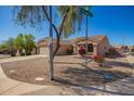 Lovely one-story home with low-maintenance landscaping and mature tree, situated on the corner of an intersection at 14514 N 128Th Dr, El Mirage, AZ 85335