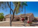 Lovely one-story home with low-maintenance landscaping and mature tree, situated on the corner of an intersection at 14514 N 128Th Dr, El Mirage, AZ 85335
