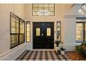 Elegant front entry with double doors, black and white tile, sidelights and views of a chandelier at 14862 N 90Th Pl, Scottsdale, AZ 85260