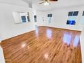 Bright living room featuring hardwood floors, white walls, and ample natural light at 14950 W Rockrose Way, Surprise, AZ 85374