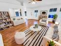 Bright living room features hardwood floors, a modern rug, and a comfortable seating area at 14950 W Rockrose Way, Surprise, AZ 85374