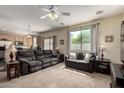 Inviting living room featuring plush seating, neutral carpet, and large window with backyard views at 15054 N 173Rd Dr, Surprise, AZ 85388