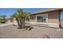 Lovely desert home with attractive landscaping, including mature palm trees and decorative stone accents at 1562 E Gleneagle Dr, Chandler, AZ 85249