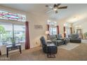 Comfortable living room features large windows with decorative glass, plush seating, and a cozy atmosphere at 1562 E Gleneagle Dr, Chandler, AZ 85249