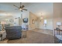Inviting living room with vaulted ceilings, neutral paint, a fan and plush seating area with TV at 1562 E Gleneagle Dr, Chandler, AZ 85249