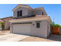 Two-story home featuring neutral paint, tile roof, and a spacious two-car garage with low maintenance landscaping at 15808 N 164Th Ln, Surprise, AZ 85388