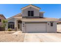 Two-story home featuring neutral paint, tile roof, and a spacious two-car garage with desert landscaping at 15808 N 164Th Ln, Surprise, AZ 85388