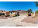 Attractive single-story home features a two-car garage and low-maintenance desert landscaping for easy living at 17290 N 170Th Ln, Surprise, AZ 85374