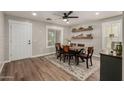Charming dining room with wood floors, a stylish rug, and decorative shelving at 1753 E Maddison Cir, San Tan Valley, AZ 85140