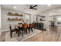 Bright dining area with wood floors and decorative shelves, flowing into the open kitchen at 1753 E Maddison Cir, San Tan Valley, AZ 85140