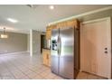 Bright eat-in kitchen with stainless steel appliances, tile floor, and natural wood cabinets at 2110 E Kathleen Rd, Phoenix, AZ 85022
