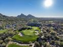Picturesque golf course view featuring lush green fairways, sand traps, and scenic mountain backdrop at 29121 N 105Th St, Scottsdale, AZ 85262
