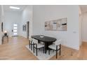 Elegant dining room featuring a modern table and chairs, with wood flooring and skylights at 2927 E Osborn Rd, Phoenix, AZ 85016