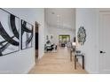 Bright foyer with wood floors and modern decor leading into open living spaces at 2927 E Osborn Rd, Phoenix, AZ 85016